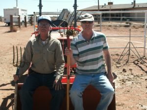 Billy and Terry on tractor with pitch forks