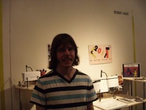 Bobby in front of his BFA Senior Thesis Show display