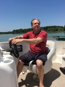 My cousin Dennis taking us for a boat ride on Lake Waco, TX