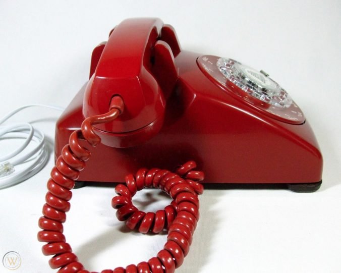 red rotary landline phone with cord